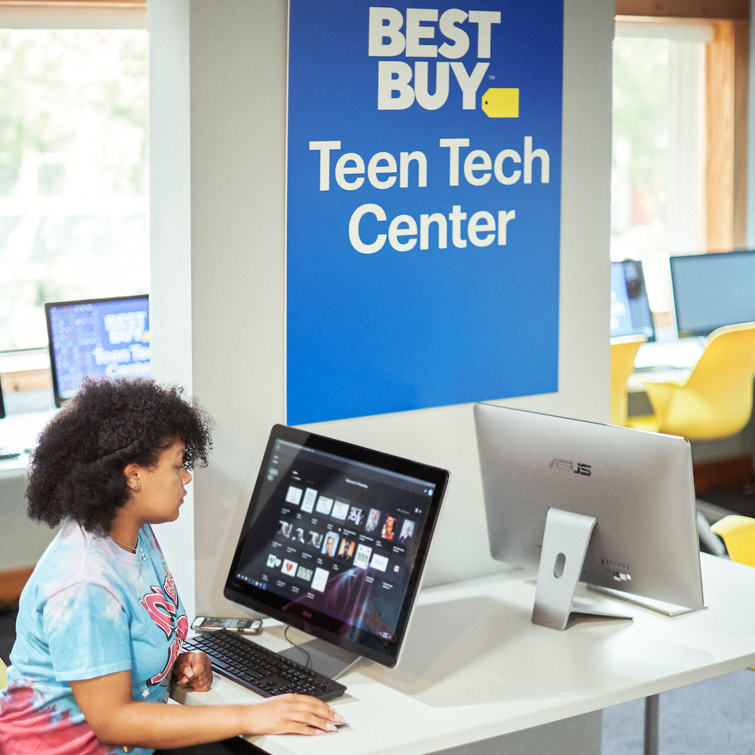 teen sitting at a computer at a Teen Tech Center