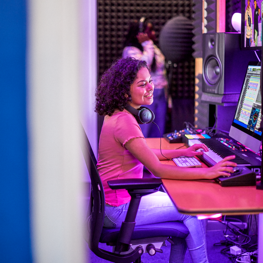 Teen editing music in a sound booth