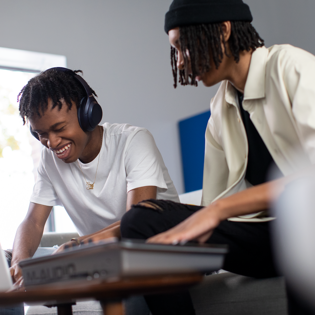 two teens are making music together