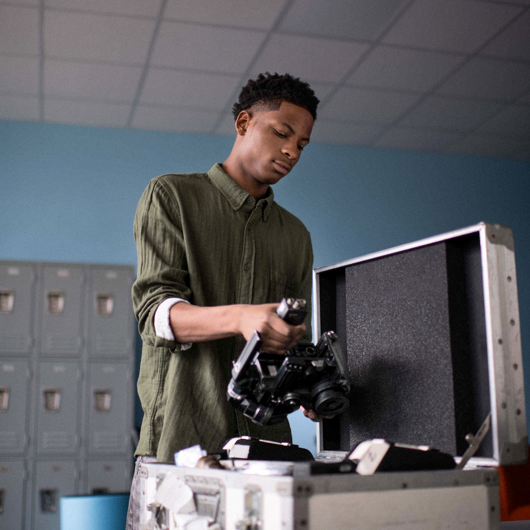 teen shooting a close up of some gear