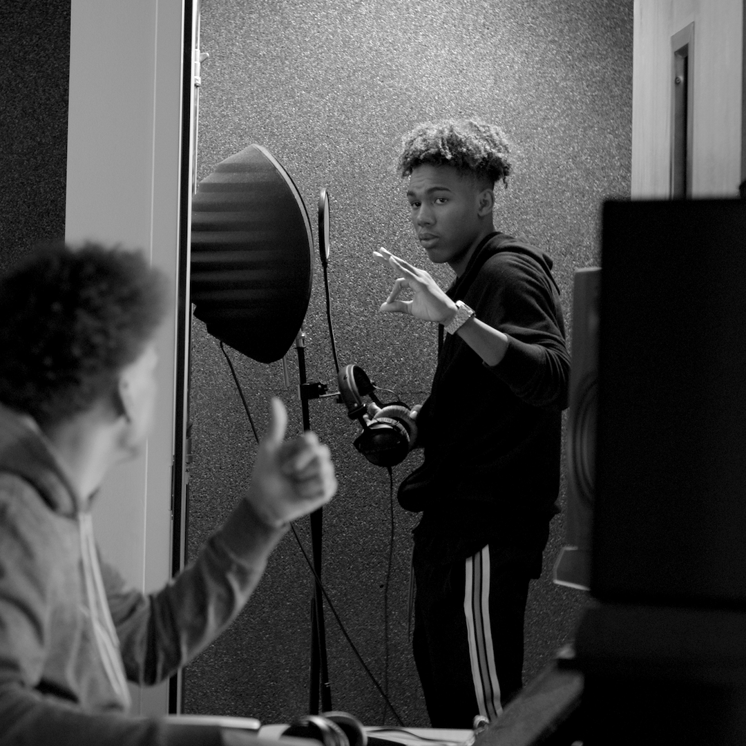 teen getting ready to sing in a sound booth